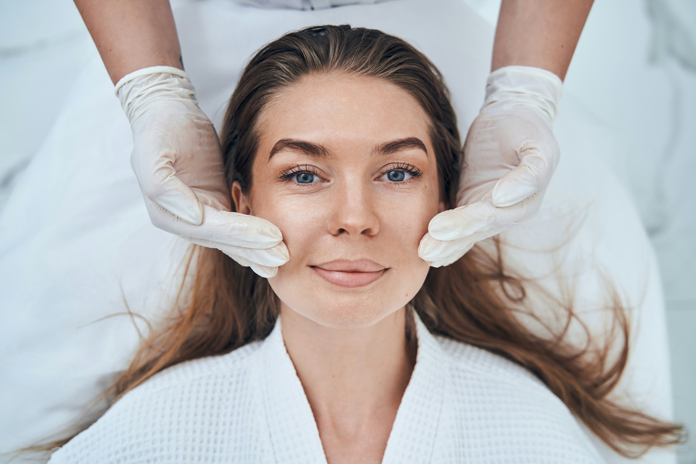 A close-up of a practitioner administering a facial injection
